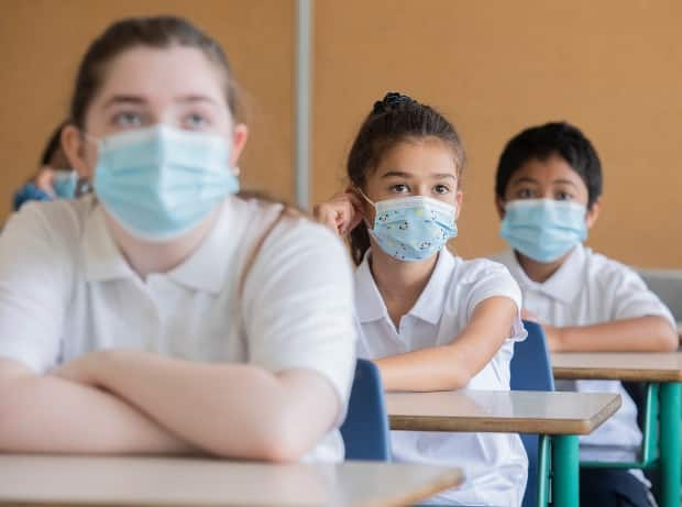 Unvaccinated school-age children who are close contacts to a positive case of COVID-19 don't have to self-isolate, as long as they have no symptoms and wear a face covering, according to the province. (Graham Hughes/The Canadian Press - image credit)