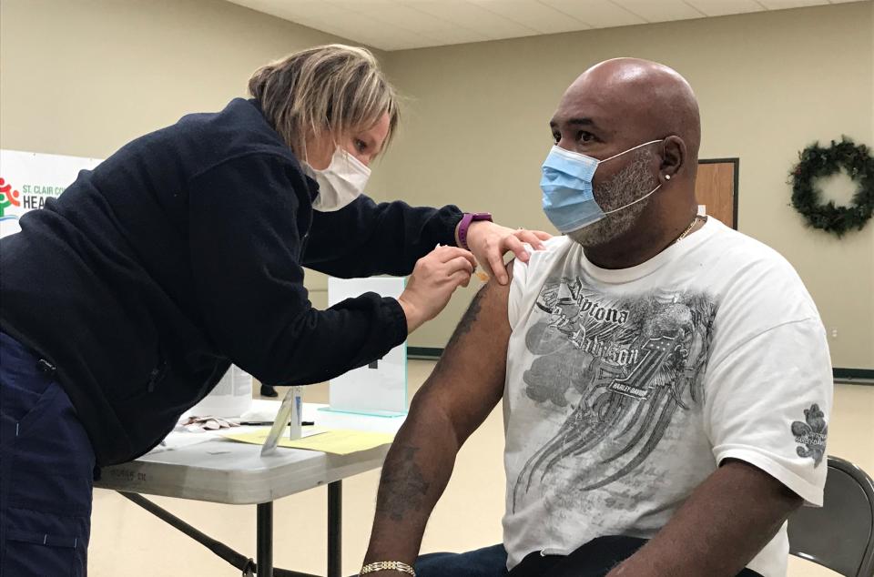 A Port Huron resident receives a coronavirus vaccine on Friday, March 12, 2021, at the Eleger G. Harvey Reinvestment Center In Port Huron. It was among the special clinics set up through the county health department to help minority populations of residents get better access to the vaccine.