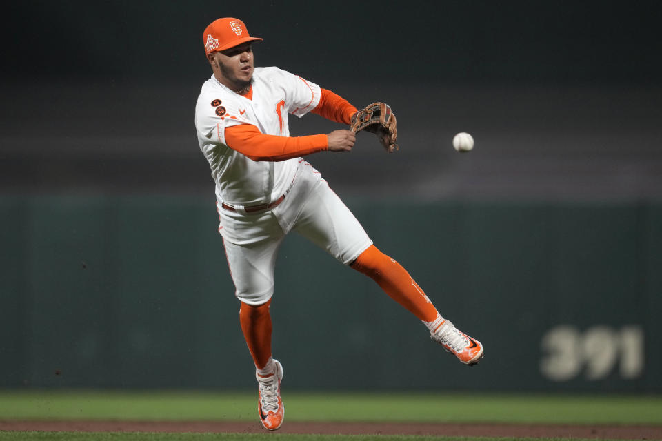 San Francisco Giants second baseman Thairo Estrada commits a throwing error on an infield single hit by San Diego Padres' Xander Bogaerts that allowed Brett Sullivan to advance to third base during the third inning of a baseball game in San Francisco, Tuesday, Sept. 26, 2023. (AP Photo/Jeff Chiu)