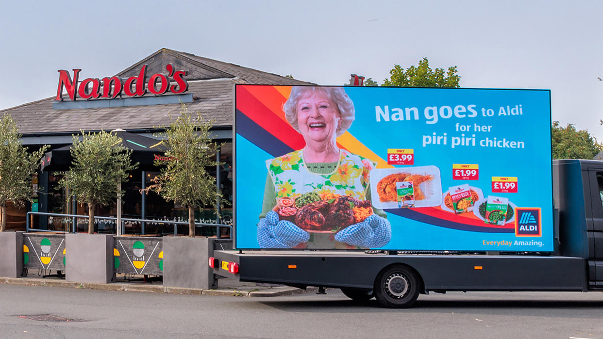  Aldi billboard outside of a Nando's restaurant 