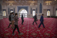 Abit Qazbay, right, an instructor at the Xinjiang Islamic Institute, and government officials walk through the prayer hall during a government organized visit for foreign journalists at the institute's campus in Urumqi in western China's Xinjiang Uyghur Autonomous Region, on April 22, 2021. Under the weight of official policies, the future of Islam appears precarious in Xinjiang, a remote region facing Central Asia in China's northwest corner. Outside observers say scores of mosques have been demolished, which Beijing denies, and locals say the number of worshippers is on the decline. (AP Photo/Mark Schiefelbein)
