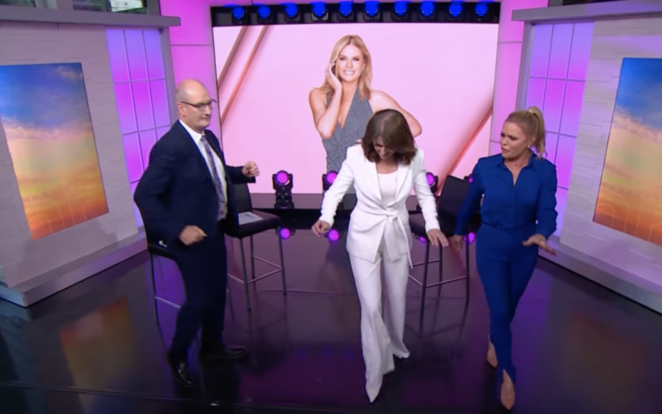 Sonia Kruger dances with David Koch and Natalie Barr on Sunrise. 