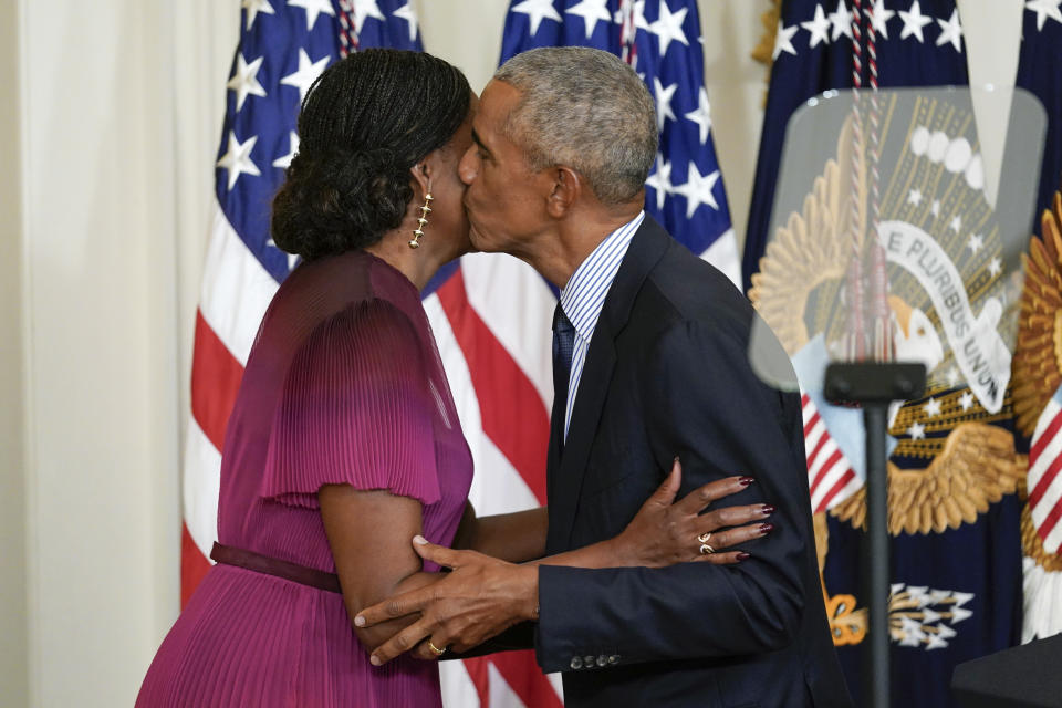 Former President Barack Obama kisses former first lady Michelle Obama after he introduced her to speak during a ceremony in the East Room of the White House, Wednesday, Sept. 7, 2022, in Washington. The Obama's unveiled their official White House portraits during the ceremony. (AP Photo/Andrew Harnik)