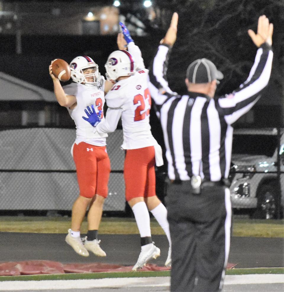 Brody Lester and Christian McDonald celebrate Lester's rushing touchdown against the Wildcats