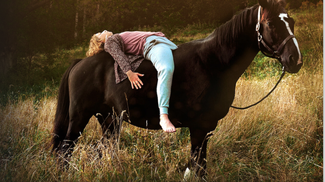 a girl laying on the back of a horse in rock my heart