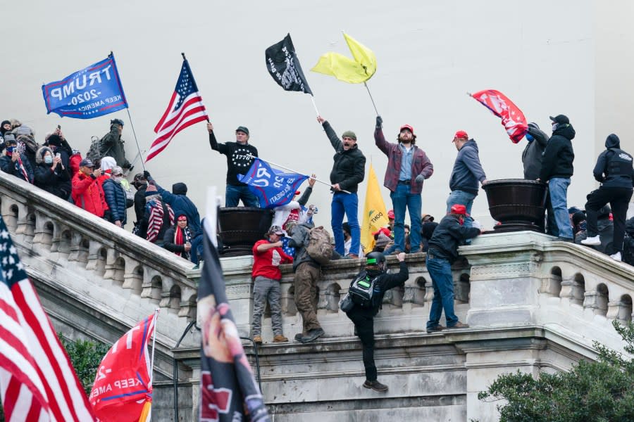 Rioters wave flags on the West Front of the U.S. Capitol in Washington during the insurrection on Jan. 6, 2021. Former President Donald Trump faces charges based on actions leading up to that day. (AP Photo by Jose Luis Magana, File)