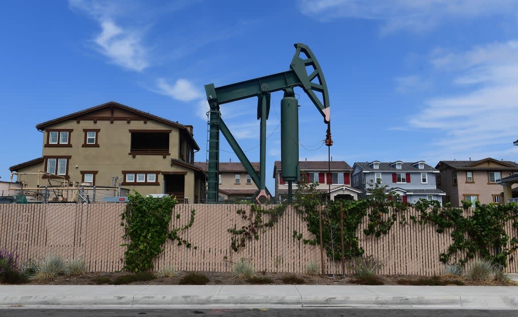 A pumpjack stands out among homes in residential Signal Hill, south of Los Angeles, California, on September 25, 2019 where oil has been pumped since the 1920's.  (AFP via Getty Images)