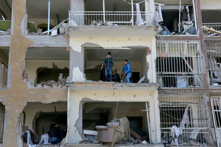 Residents search for their belongings at a building, which was damaged during Friday's car bomb attack, in the Kurdish-dominated southeastern city of Diyarbakir, Turkey, November 5, 2016. REUTERS/Sertac Kayar