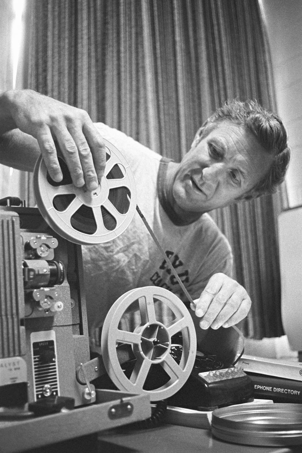 BYU quarterbacks coach and offensive coordinator Doug Scovil prepares a film strip for viewing in 1977. | BYU Photo