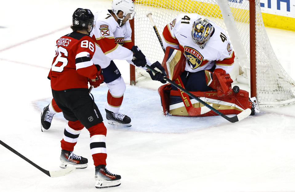 Florida Panthers goaltender Anthony Stolarz (41) makes a save against New Jersey Devils center Jack Hughes (86) during the third period of an NHL hockey game, Tuesday, March 5, 2024, in Newark, N.J. The Florida Panthers won 5-3. (AP Photo/Noah K. Murray)