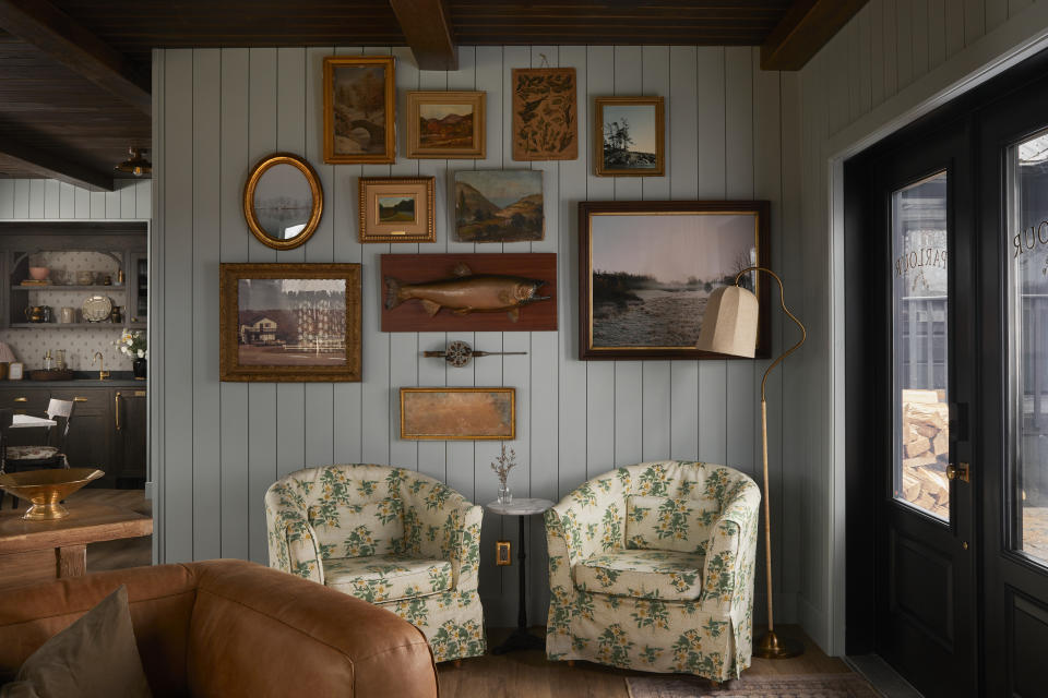 An entryway space with two flower patterned accent chairs