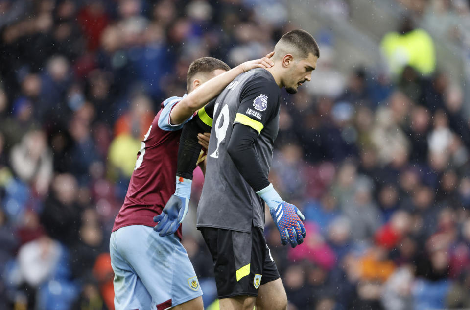 Burnley goalkeeper Arijanet Muric, right, reacts after conceding an own goal, Brighton and Hove Albion's first of the game during during the English Premier League soccer match between Burnley and Brighton and Hove Albion at the Turf Moor stadium in Burnley, England, Saturday, April 13, 2024. (Richard Sellers/PA via AP)
