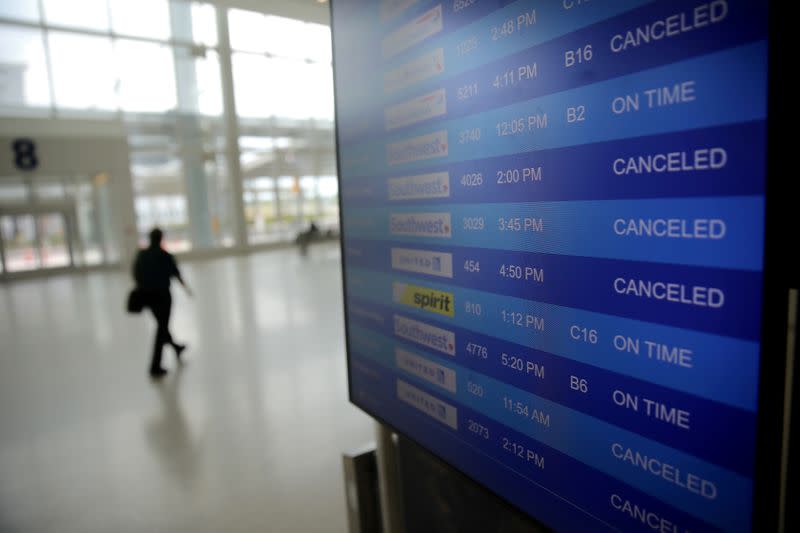 FILE PHOTO: Canceled flights are seen on an airport screen in New Orleans