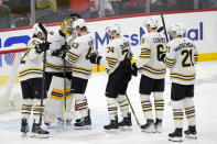 Boston Bruins players celebrate after the Bruins beat the Florida Panthers 2-1 during Game 5 of the second-round series of the Stanley Cup Playoffs, Tuesday, May 14, 2024, in Sunrise, Fla. (AP Photo/Wilfredo Lee)