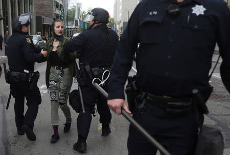 An anti-fascist protestor is detained by law enforcement during the Patriots Day Free Speech Rally in Berkeley, California, U.S. April 15, 2017. REUTERS/Jim Urquhart