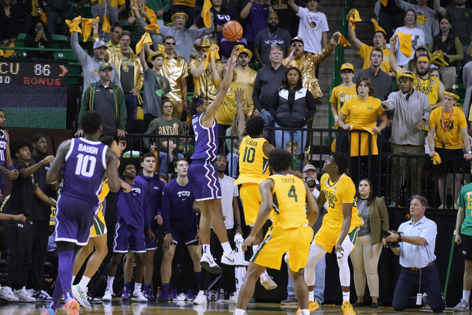 TCU forward Chuck O'Bannon Jr. (5) shoots over Baylor guard Adam Flagler (10) the final basket of an NCAA college basketball game in Waco, Texas, Wednesday, Jan. 4, 2023. TCU won 88-87. (AP Photo/LM Otero)