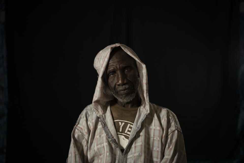 In this Nov. 26, 2018 photo, Cheikh Fofana poses for a picture before an interview in Goudiry, Senegal. Fofana grieves his son, Tidiane's absence, even while refusing to officially acknowledge he is dead. Tidiane was one of 18 children; though the only one who noticed when his aging father or widowed aunt needed help. It was Tidiane who wanted to reach Europe to earn enough so that Fofana would never again have to ride his bicycle to the family's fields to work. (AP Photo/Felipe Dana)