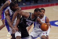 Sacramento Kings forward Harrison Barnes (40) is fouled by Detroit Pistons center Isaiah Stewart, left, next to Detroit Pistons guard Dennis Smith Jr. (0) during the first half of an NBA basketball game, Friday, Feb. 26, 2021, in Detroit. (AP Photo/Carlos Osorio)