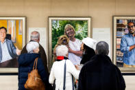 Visitors examine Artist Betsy Ashton's exhibition, "Portraits of Immigrants: Unknown Faces, Untold Stories" at Riverside Church in New York, U.S., March 10, 2019. REUTERS/Demetrius Freeman