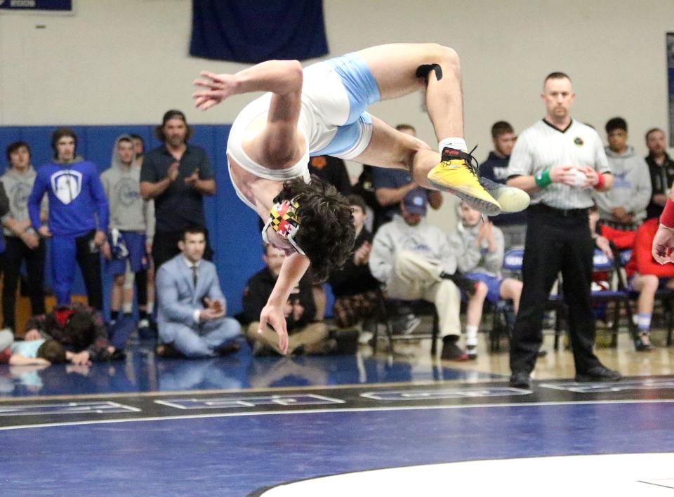 MMU's Jack Arpey does a backflip after claiming the 160 pound title at the 2023 Vermont State championships on Saturday night at Vergennes High School.