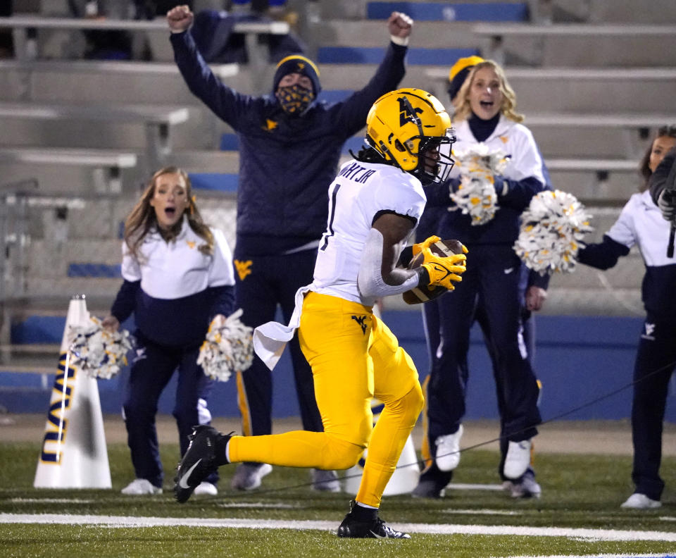 West Virginia wide receiver Winston Wright Jr. runs in for a touchdown against Kansas during the first quarter of an NCAA college football game Saturday, Nov. 27, 2021, in Lawrence, Kan. (AP Photo/Ed Zurga)