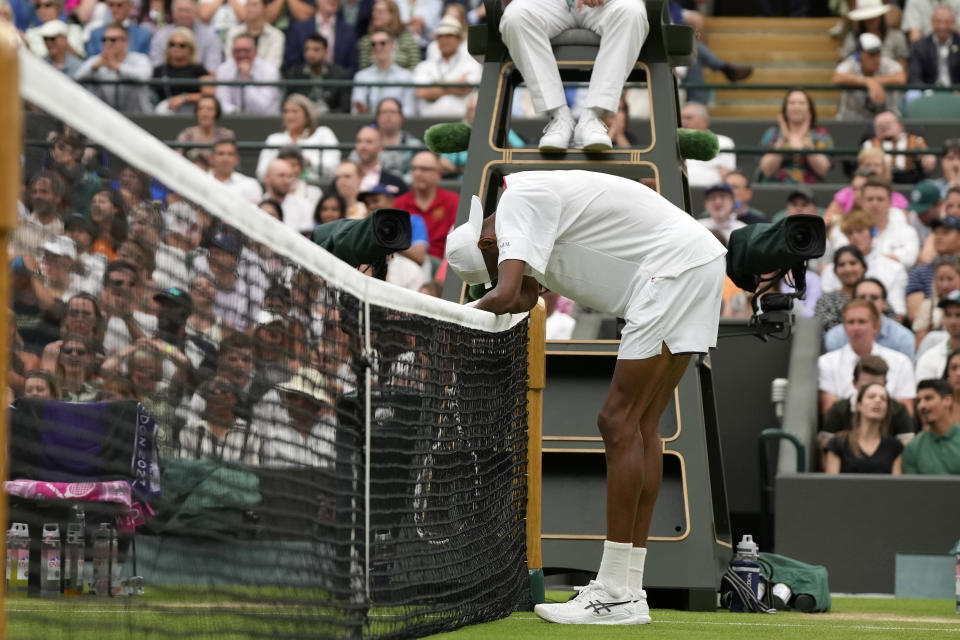 Christopher Eubanks of the US at the net during his men's singles match against Russia's Daniil Medvedev on day ten of the Wimbledon tennis championships in London, Wednesday, July 12, 2023. (AP Photo/Alastair Grant)