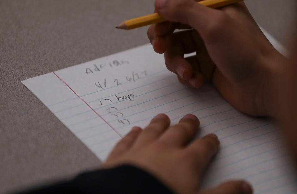 Adrian Tavares, 10, writes down words during a reading skills lesson in Angela Mosca's class at Mary Eyre Elementary School in Salem, Ore. on Tuesday, April 26, 2022.