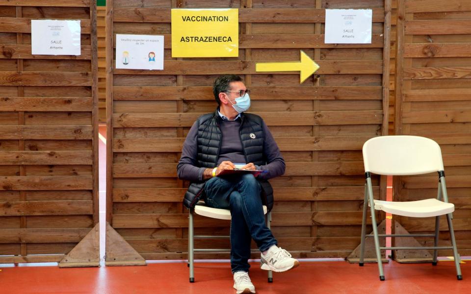 A man waits to get vaccinated with the AstraZeneca jabin a vaccination center of Saint-Jean-de-Luz, southwestern France - Bob Edme /AP