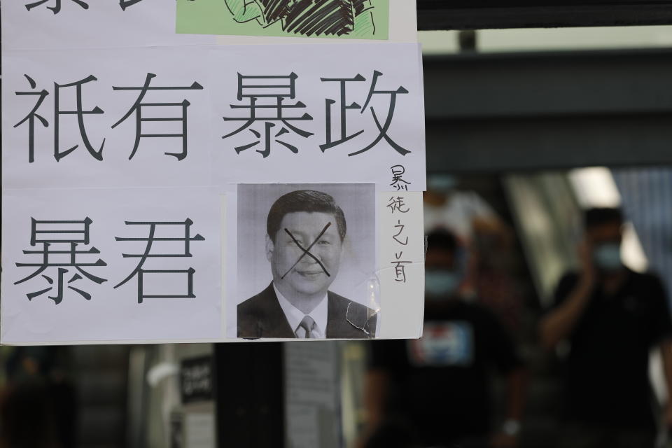 A defaced poster of Chinese President Xi Jinping with part of a message that reads "There are no rioters, there is only trranny," stands on a new Lennon Wall in Hong Kong, Saturday, Sept. 28, 2019. Hong Kong activists first created their own Lennon Wall during the 2014 protests, covering a wall with a vibrant Post-it notes calling for democratic reform. Five years later, protestors have gathered to create impromptu Lennon Walls across Hong Kong island. (AP Photo/Vincent Thian)