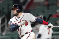 Atlanta Braves catcher Travis d'Arnaud follows through on a two-run double in the third inning inning of a baseball game against the Cincinnati Reds Friday, April 8, 2022, in Atlanta. (AP Photo/John Bazemore)