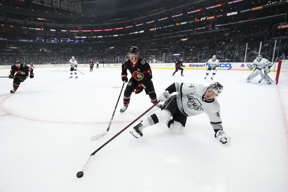 Los Angeles Kings defenseman Mikey Anderson (44) and Ottawa Senators left wing Brady Tkachuk (7) battle for the puck in the first period of an NHL hockey game Saturday, Nov. 27, 2021, in Los Angeles. (AP Photo/Kyusung Gong)