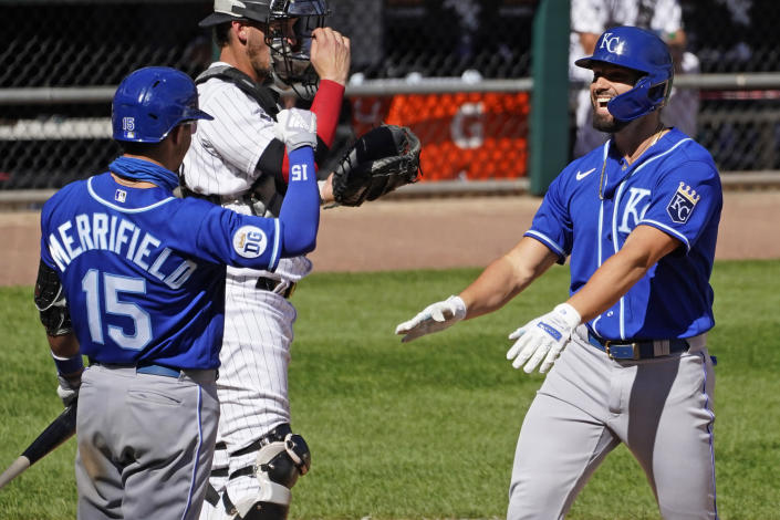 Kansas City Royals' Ryan McBroom, right, smiles as he celebrates with Whit Merrifield after hitting a solo home run during the seventh inning of a baseball game against the Chicago White Sox in Chicago, Saturday, Aug. 29, 2020. (AP Photo/Nam Y. Huh)