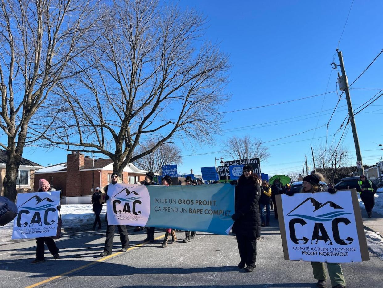 Demonstrators in McMasterville, Que., told CBC on Sunday that the provincial government needs to be fully transparent with Quebecers over the Northvolt EV battery plant project.  (Chloë Ranaldi/CBC - image credit)