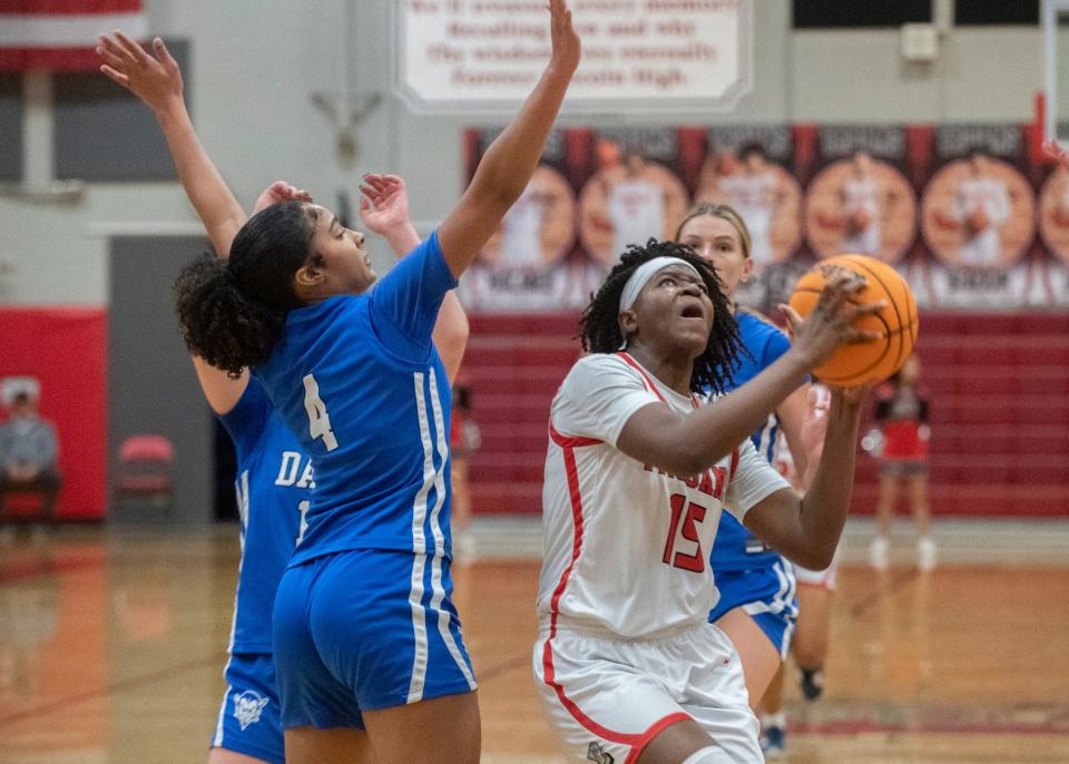 Lincoln's Brelynn Brice, right, goes to the hoop against Davis Sr. High's Jiana Trotman during an opening round game of the Sac-Joaquin Section girls basketball division 1 playoffs at Lincoln in Stockton on Feb. 14, 2024.