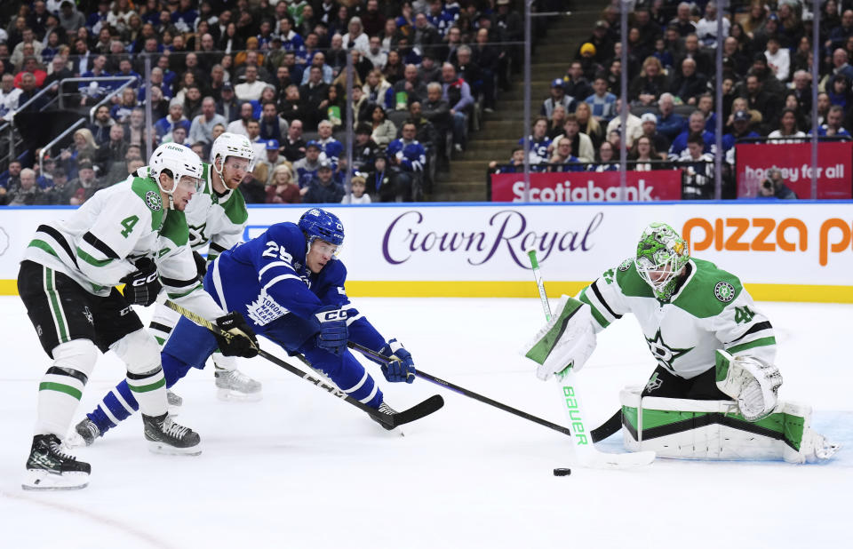 Dallas Stars goaltender Scott Wedgewood (41) stops Toronto Maple Leafs forward Pontus Holmberg (29) as Stars defenseman Miro Heiskanen (4) and forward Radek Faksa (12) defend during the second period of an NHL hockey game Wednesday, Feb. 7, 2024, in Toronto. (Nathan Denette/The Canadian Press via AP)