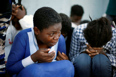 FILE PHOTO: Migrants arrive at a naval base after they were rescued by Libyan coastal guards in Tripoli, Libya November 6, 2017. REUTERS/Ahmed Jadallah/File Photo