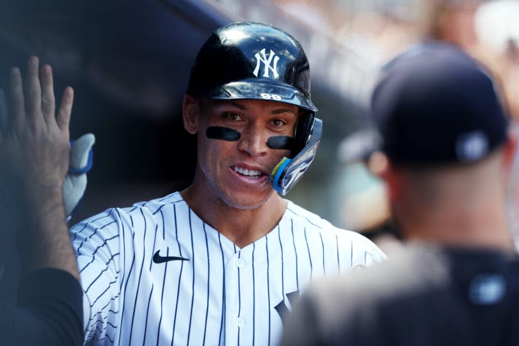 Aaron Judge #99 of the New York Yankees is congratulated after he hit a two-run home run against the Kansas City Royals during the third inning of a game at Yankee Stadium on July 30, 2022 in New York City. (Photo by Rich Schultz/Getty Images)