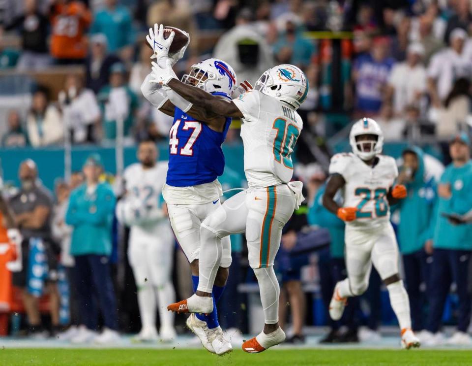 Buffalo Bills cornerback Christian Benford (47) intercepts a pass to Miami Dolphins wide receiver Tyreek Hill (10) in the first quarter of an NFL game at Hard Rock Stadium on Sunday, Jan. 7, 2023, in Miami Gardens Fla. MATIAS J. OCNER/mocner@miamiherald.com