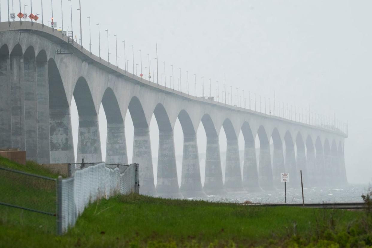 Confederation Bridge tolls and Wood Islands ferry fees won't change until at least the end of 2026, according to measures in the federal budget. (Radio-Canada - image credit)