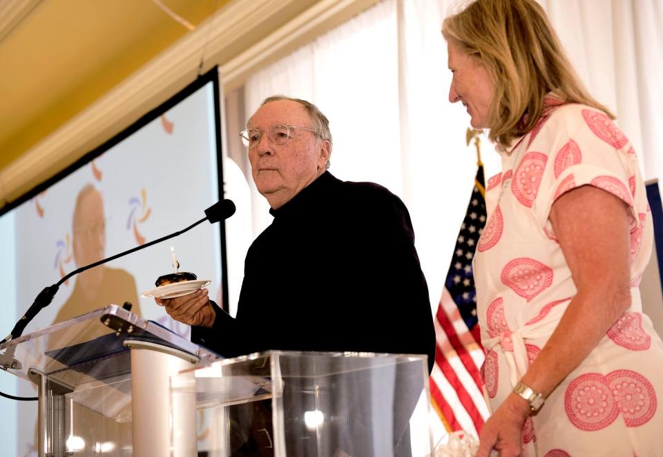 Author James Patterson holds a birthday doughnut (Boston cream) given to him Mary Robosson after he spoke during the Palm Beach Civic Association annual award breakfast at The Breakers in March 2023. This year's breakfast is March 18 at The Breakers.