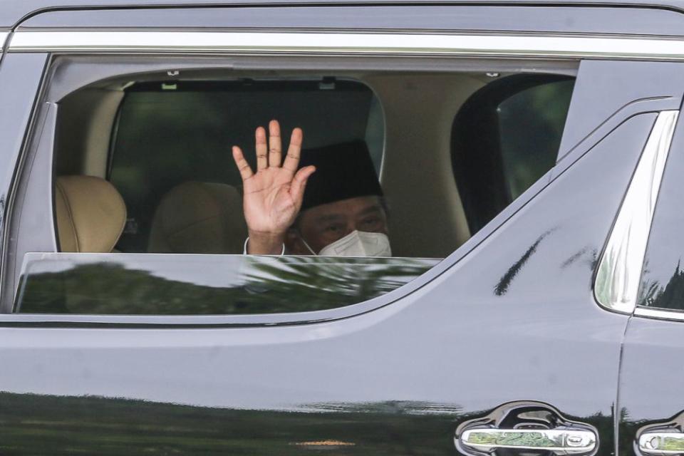 Prime Minister Tan Sri Muhyiddin Yassin waves at reporters as he leaves Istana Negara following an audience with the Yang di-Pertuan Agong in Kuala Lumpur August 4, 2021. — Picture by Yusof Mat Isa