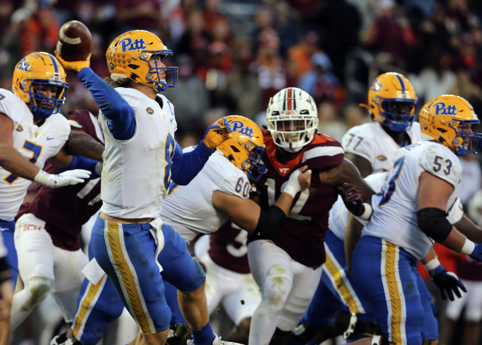 Pittsburgh quarterback Kenny Pickett (8) looks to pass while pressued by Virginia Tech defensive lineman Jordan Williams (12) in the second half of an NCAA college football game, Saturday, Oct. 16, 2021, in Blacksburg, Va. (Matt Gentry/The Roanoke Times via AP)