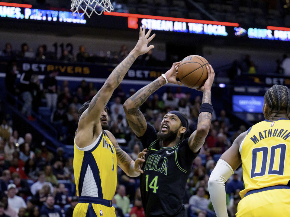 New Orleans Pelicans forward Brandon Ingram (14) shoots against Indiana Pacers forward Obi Toppin (1) during the first half of an NBA basketball game Friday, March 1, 2024, in New Orleans. (AP Photo/Matthew Hinton)