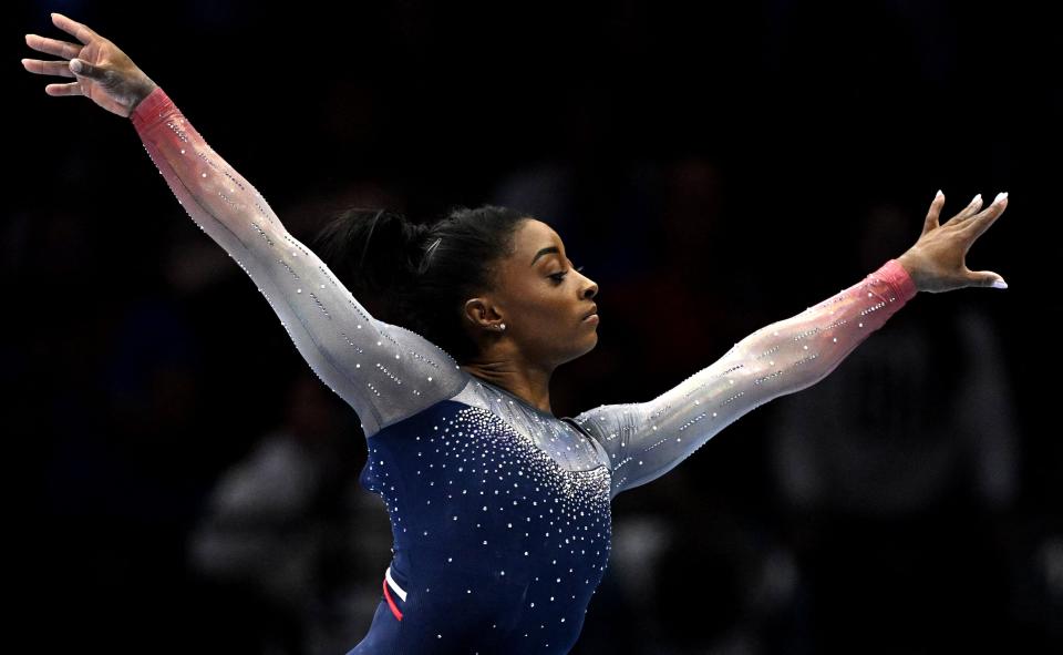 Simone Biles wears diamond earrings her mother gave her in Antwerp after her first world championship in 2013 while she competes on the balance beam in the Women's Team Final during the 2023 World Championships in the same city on October 4, 2023.