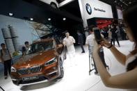 People gather around a long wheelbase BMW X1 xDrive25Li after it was presented during the Auto China 2016 auto show in Beijing April 25, 2016. REUTERS/Damir Sagolj