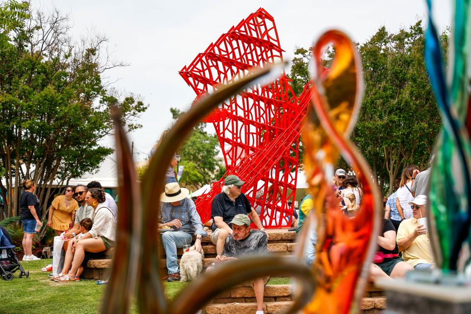 People sit to rest and eat at the Paseo Art Festival in Oklahoma City, on Saturday, May 27, 2023.