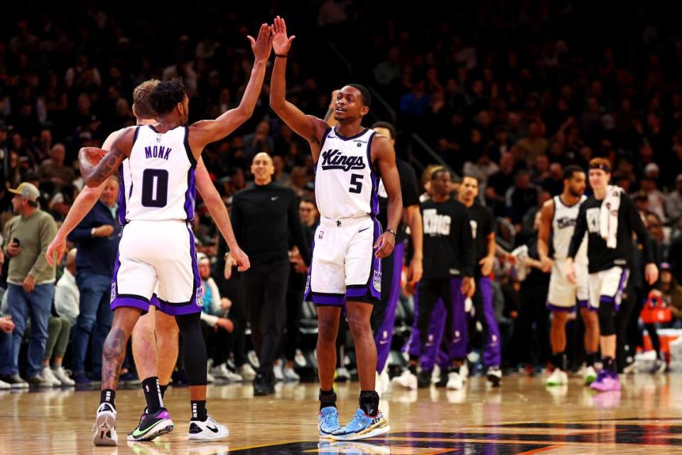 Sacramento Kings guard De’Aaron Fox (5) celebrates with guard Malik Monk (0) during the second quarter against the Phoenix Suns on Tuesday, Jan. 16, 2024, at Footprint Center in Phoenix, Arizona.