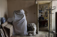 A sheet covers a sculpture of the Andrey Sheptytsky National Museum in Lviv, western Ukraine, Friday, March 4, 2022. The doors of the museum have been closed since Russia's war on Ukraine began on Feb. 24, and heritage sites across the country face danger as the fighting continues. (AP Photo/Bernat Armangue)