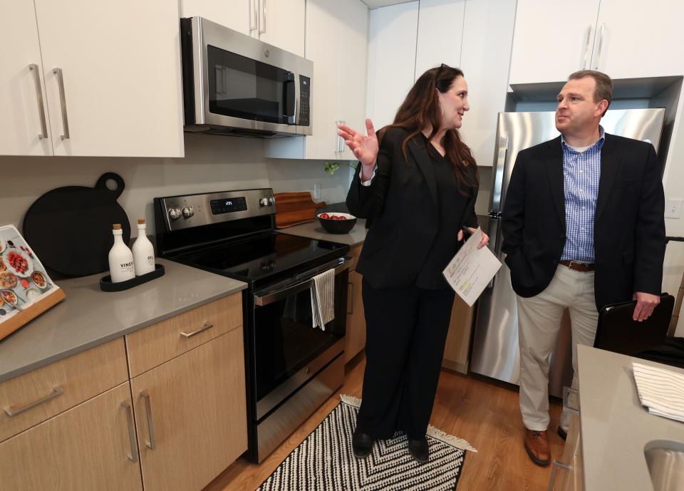 Tiffani Farnell, Evergreen Marketing Group director of marketing, shows Jonathan Hanks, Utah Housing Corporation COO, the kitchen in a two-bedroom apartment in The Aster, a three-building development that includes low-income housing, commercial and public spaces, in Salt Lake City on Tuesday, May 2, 2023. | Kristin Murphy, Deseret News