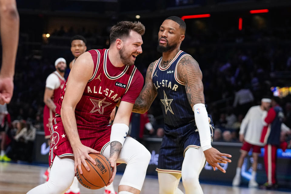 Dallas Mavericks guard Luka Doncic (77) drives on Milwaukee Bucks guard Damian Lillard (0) during the first half of an NBA All-Star basketball game in Indianapolis, Sunday, Feb. 18, 2024. (AP Photo/Darron Cummings)